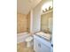 Bathroom with tile shower, bathtub, and white vanity with granite top at 1230 Tagliamento Ln, Haines City, FL 33844