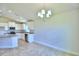 Spacious dining area with chandelier and view of kitchen at 1230 Tagliamento Ln, Haines City, FL 33844