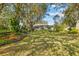 Landscaped backyard with mature trees at 150 Woodcrest Ln, Mulberry, FL 33860