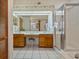 Double vanity bathroom with shower and wood cabinets at 150 Woodcrest Ln, Mulberry, FL 33860