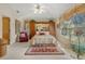 Spacious main bedroom with a large bed and built in wooden wardrobe at 150 Woodcrest Ln, Mulberry, FL 33860