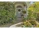 Inviting front door entry with decorative wreath and potted plants at 150 Woodcrest Ln, Mulberry, FL 33860