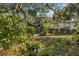 Welcoming front entrance with lush landscaping and gray door at 150 Woodcrest Ln, Mulberry, FL 33860