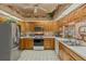 View of kitchen with stainless steel appliances and wood cabinets at 150 Woodcrest Ln, Mulberry, FL 33860