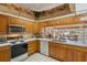 Bright kitchen with stainless steel appliances and wood cabinets at 150 Woodcrest Ln, Mulberry, FL 33860