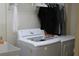 Laundry room with washer, dryer, and utility sink at 150 Woodcrest Ln, Mulberry, FL 33860