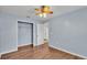 Bedroom with wood-look floors, ceiling fan, and a closet at 1555 Archers Path, Lakeland, FL 33809