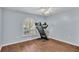 Bedroom featuring wood-look floors, a window with shutters, and a treadmill at 1555 Archers Path, Lakeland, FL 33809