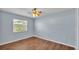Spacious bedroom with wood-look flooring and a ceiling fan at 1555 Archers Path, Lakeland, FL 33809
