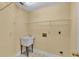 Bright laundry room with utility sink and ample shelving at 1555 Archers Path, Lakeland, FL 33809