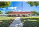 Community building exterior with manicured lawn and flagpoles at 1610 Reynolds Rd # 79, Lakeland, FL 33801