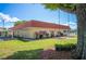 Community building with landscaping and red tile roof at 1610 Reynolds Rd # 79, Lakeland, FL 33801