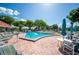 Inviting community pool with lounge chairs and patio tables at 1610 Reynolds Rd # 79, Lakeland, FL 33801