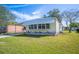 Single-wide yellow manufactured home with landscaped lawn at 1610 Reynolds Rd # 79, Lakeland, FL 33801