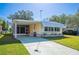 Cute yellow mobile home with carport and landscaped lawn at 1610 Reynolds Rd # 79, Lakeland, FL 33801