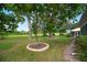 Backyard with mature trees and landscaped area at 202 Golf Aire Blvd, Winter Haven, FL 33884