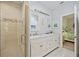 Bathroom with double vanity, marble countertop, and shower at 202 Golf Aire Blvd, Winter Haven, FL 33884