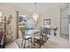 Bright dining room featuring a glass-top table and chandelier at 202 Golf Aire Blvd, Winter Haven, FL 33884