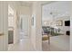 Bright hallway with tile floors, leading to bathroom and living area at 202 Golf Aire Blvd, Winter Haven, FL 33884