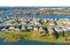 An expansive aerial view of a lakefront community, featuring multiple homes and green spaces at 2199 Ontario Way, Lakeland, FL 33805