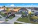 Two-story house with a three-car garage, situated on a lakefront lot with mature landscaping at 2199 Ontario Way, Lakeland, FL 33805