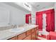 Bathroom with double vanity and red accents at 2199 Ontario Way, Lakeland, FL 33805