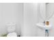 Small bathroom with toilet and pedestal sink at 2199 Ontario Way, Lakeland, FL 33805