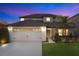 Two-story house with a two-car garage, landscaped lawn, and neutral color palette at 2199 Ontario Way, Lakeland, FL 33805