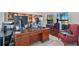Home office with a large desk, built-in shelving, and comfortable armchair at 2199 Ontario Way, Lakeland, FL 33805