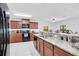 Kitchen with granite countertops, dark wood cabinets, and black appliances at 2199 Ontario Way, Lakeland, FL 33805
