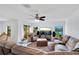 Living room with sectional sofa, large TV, and sliding glass doors at 2199 Ontario Way, Lakeland, FL 33805