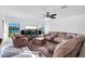 Spacious living room with large windows, sectional sofa, and ceiling fan at 2199 Ontario Way, Lakeland, FL 33805