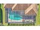 Aerial view showing house, pool, and screened patio at 3206 Heron Cv, Winter Haven, FL 33884