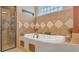 Bathroom with a large soaking tub and tile surround at 3206 Heron Cv, Winter Haven, FL 33884