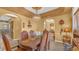 Bright dining room with a wooden table and chandelier, view into kitchen at 3206 Heron Cv, Winter Haven, FL 33884