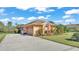 Tan house with a two-car garage and nicely landscaped yard at 3206 Heron Cv, Winter Haven, FL 33884