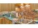 Kitchen with stainless steel sink, granite countertops, and tile backsplash at 3206 Heron Cv, Winter Haven, FL 33884