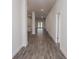 Long hallway with gray tile floors and access to other rooms at 4437 Juliana Lake Dr, Auburndale, FL 33823