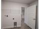Bright laundry room with shelving and access to kitchen at 4437 Juliana Lake Dr, Auburndale, FL 33823