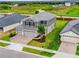 Two-story house with gray siding, tile roof, and a two-car garage in a new development at 4443 Juliana Lake Dr, Auburndale, FL 33823