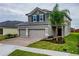 Two-story house with gray siding, tile roof, and a two-car garage at 4443 Juliana Lake Dr, Auburndale, FL 33823