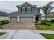 Two-story house with gray siding, tile roof, and a two-car garage at 4443 Juliana Lake Dr, Auburndale, FL 33823