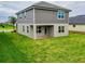 Two-story house with gray siding, covered patio, and grassy yard at 4443 Juliana Lake Dr, Auburndale, FL 33823