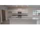 Kitchen with white cabinets and granite countertops at 4443 Juliana Lake Dr, Auburndale, FL 33823