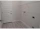 Bright laundry room with washer/dryer hookups and shelving at 4443 Juliana Lake Dr, Auburndale, FL 33823
