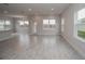Spacious living room with gray tile floor and access to backyard at 4443 Juliana Lake Dr, Auburndale, FL 33823
