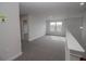 Spacious loft area with gray carpeting at 4443 Juliana Lake Dr, Auburndale, FL 33823