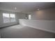 Bright loft bedroom with window and gray carpet at 4443 Juliana Lake Dr, Auburndale, FL 33823
