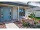Front porch with light blue door and walkway at 5108 Villa Crest Way, Auburndale, FL 33823