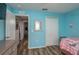 Bedroom with light blue walls, wood flooring, and mirrored closet doors at 5791 Woodruff Way, Lakeland, FL 33812